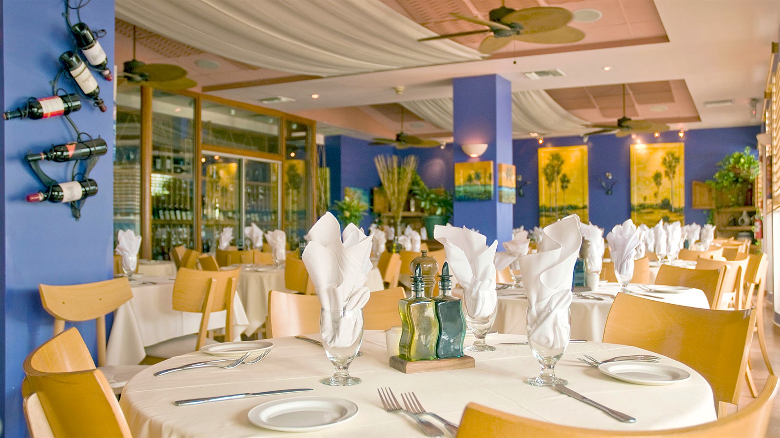 The dining room at Ragazzi, with blue walls and wooden chairs